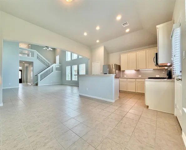a kitchen with stainless steel appliances a refrigerator sink and cabinets