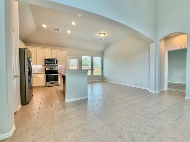 a view of a kitchen with refrigerator stove and kitchen