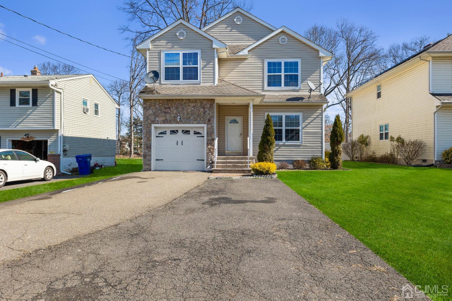 747 Magnolia Road North Brunswick, NJ 08902 - Photo 1 of 36 a front view of a house with a yard and trees