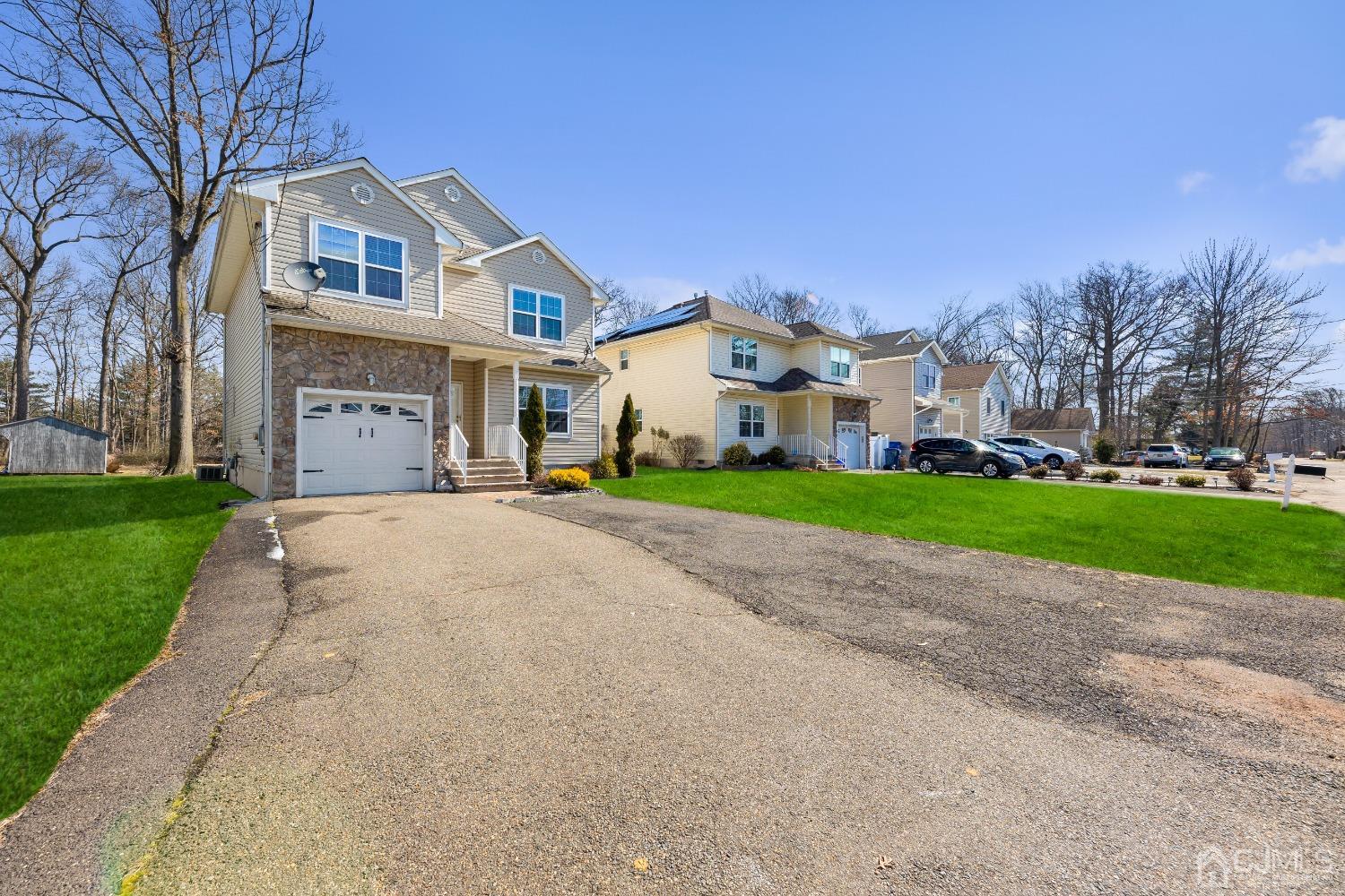 747 Magnolia Road North Brunswick, NJ 08902 - Photo 28 of 36 a front view of a house with a yard and garage