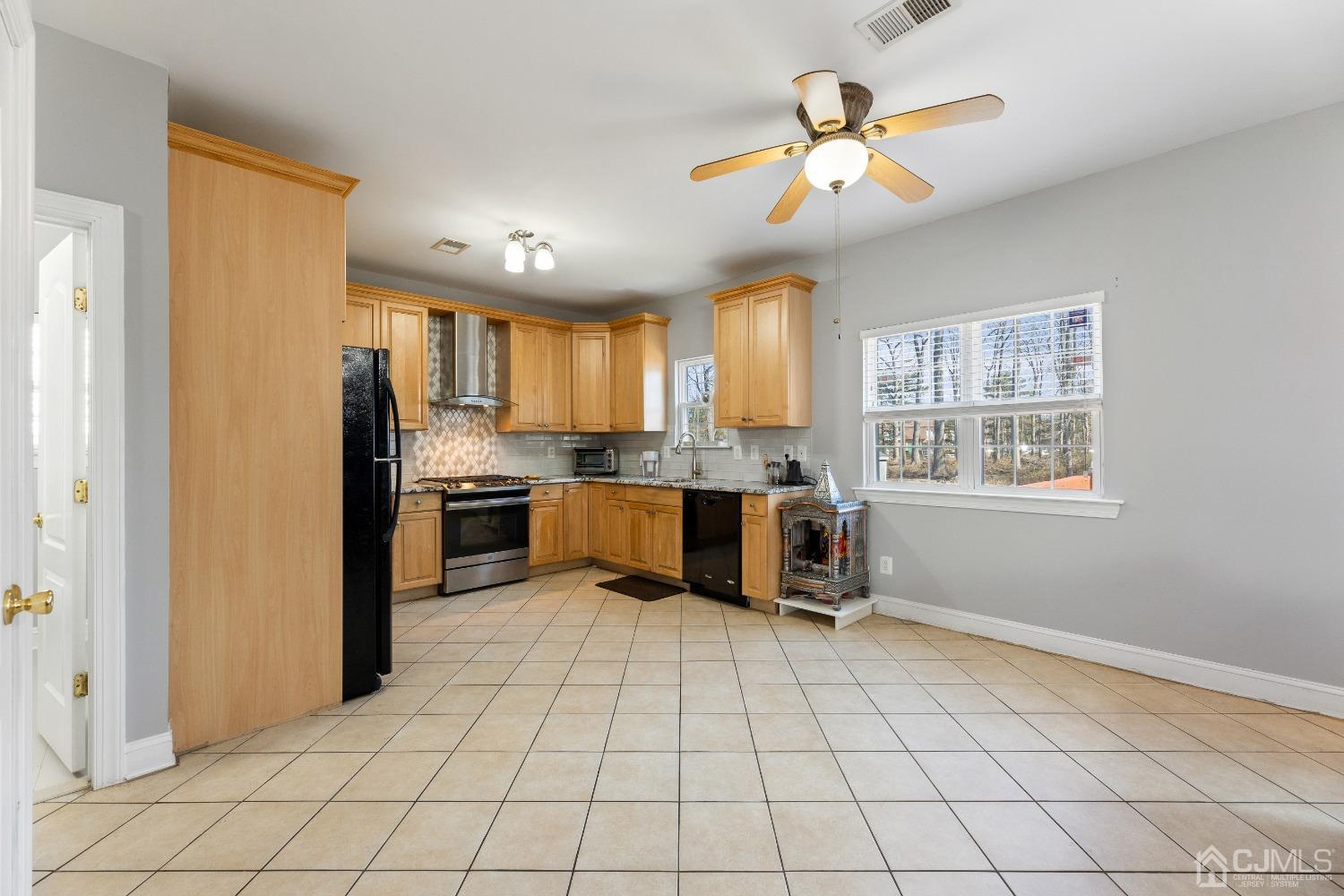 747 Magnolia Road North Brunswick, NJ 08902 - Photo 8 of 36 a kitchen with granite countertop a refrigerator and a stove top oven