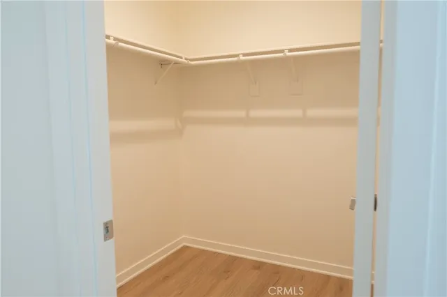 a bedroom with a bed and painting on the wall