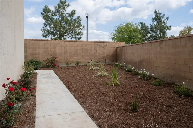 a view of a pathway along with flower pots