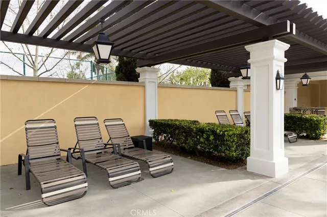 a view of a house with swimming pool and sitting area