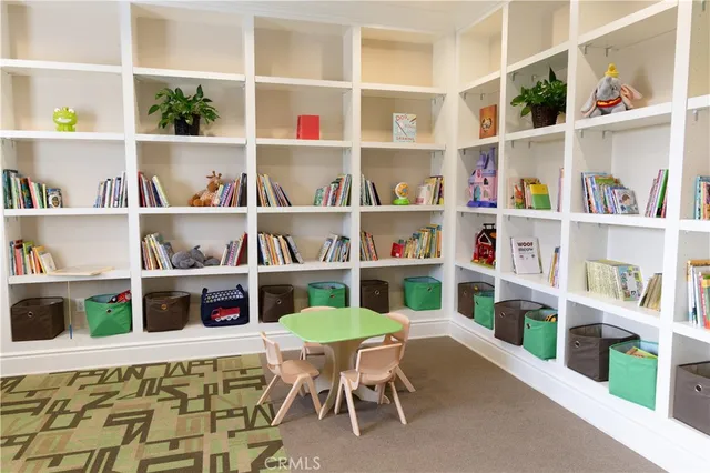 a living room with furniture and a book shelf