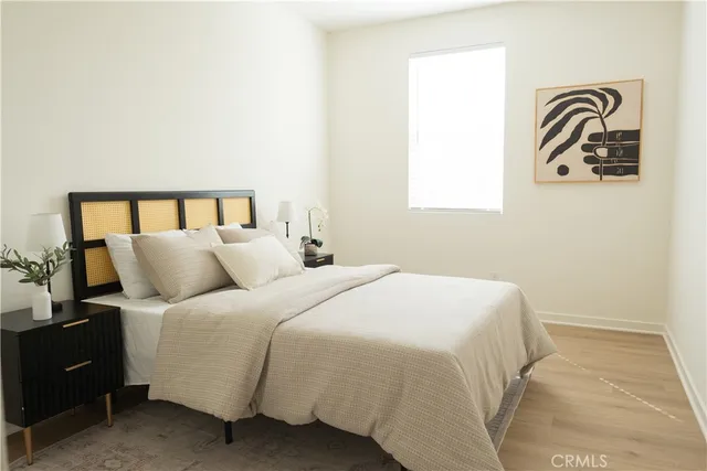 a bedroom with a bed and wall painting