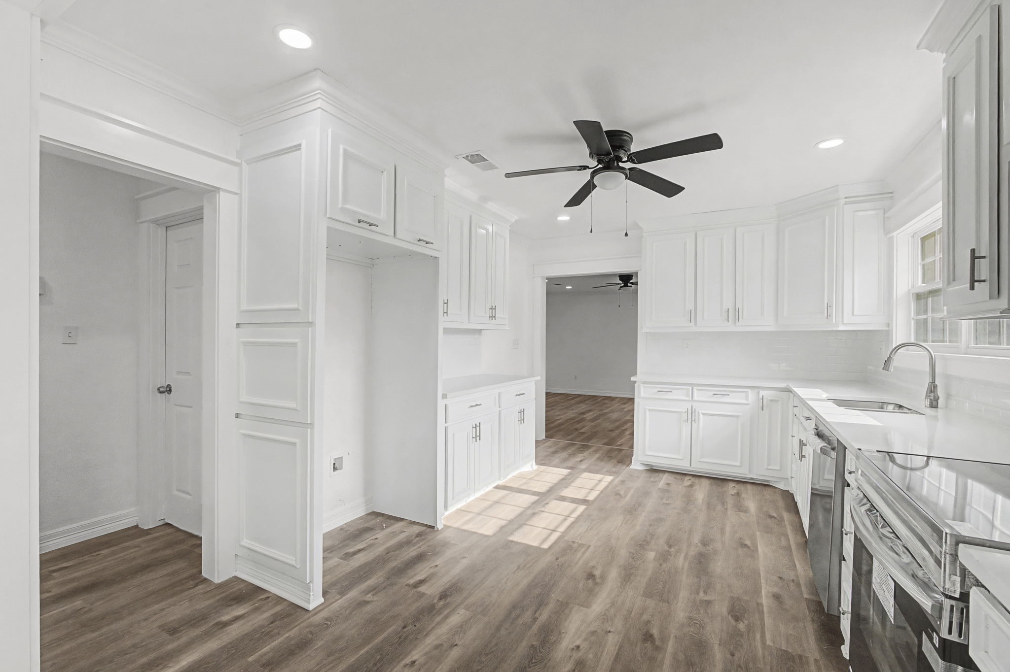 9216 Highway 69 Warren, TX 77664 - Photo 12 of 32 a kitchen with a sink cabinets stainless steel appliances and a window
