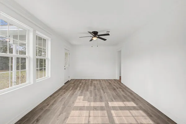 a view of a room with a ceiling fan and a window