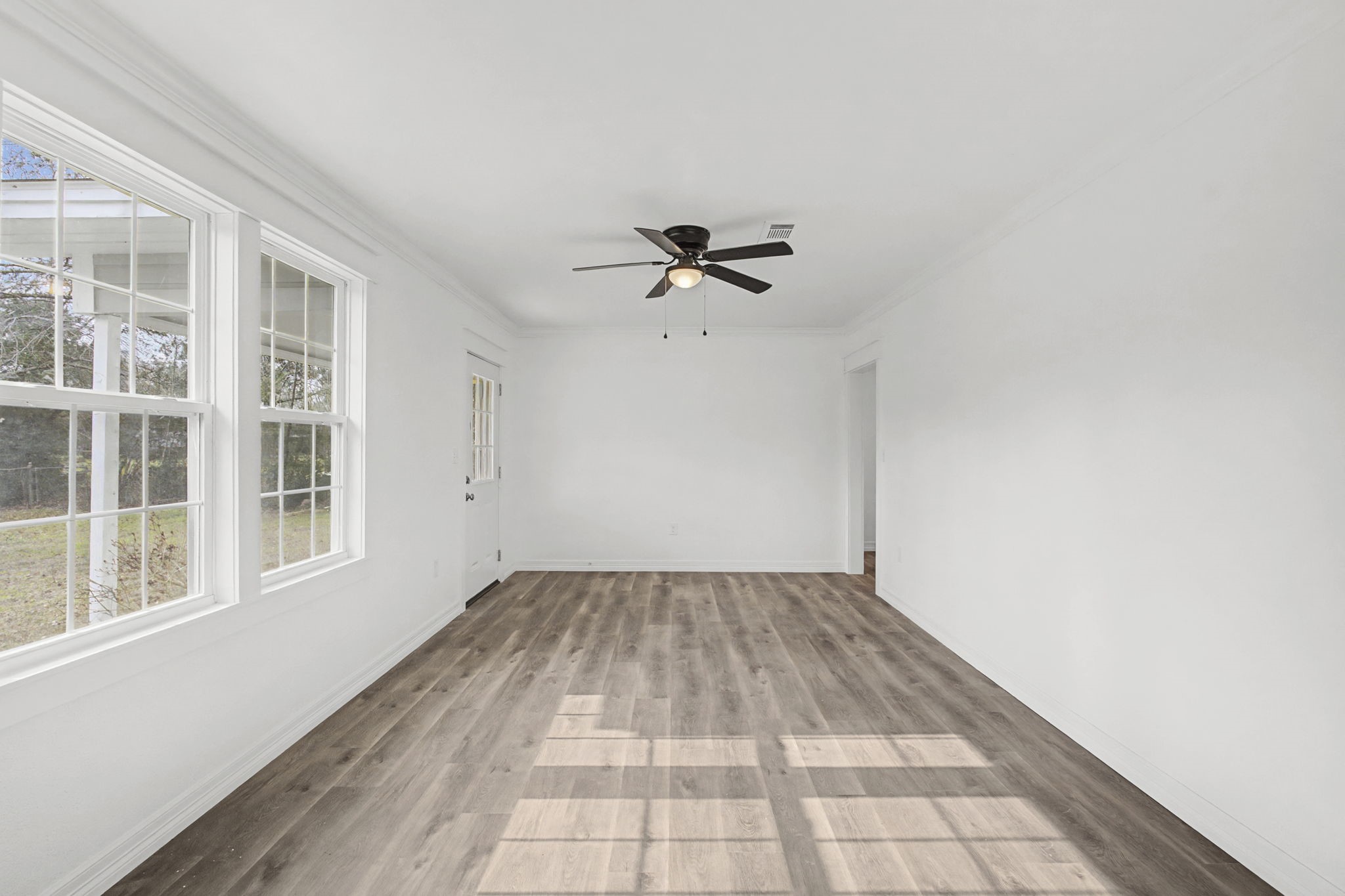 9216 Highway 69 Warren, TX 77664 - Photo 13 of 32 a view of a room with a ceiling fan and a window