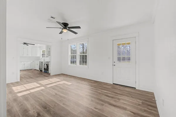 wooden floor in an empty room with a window