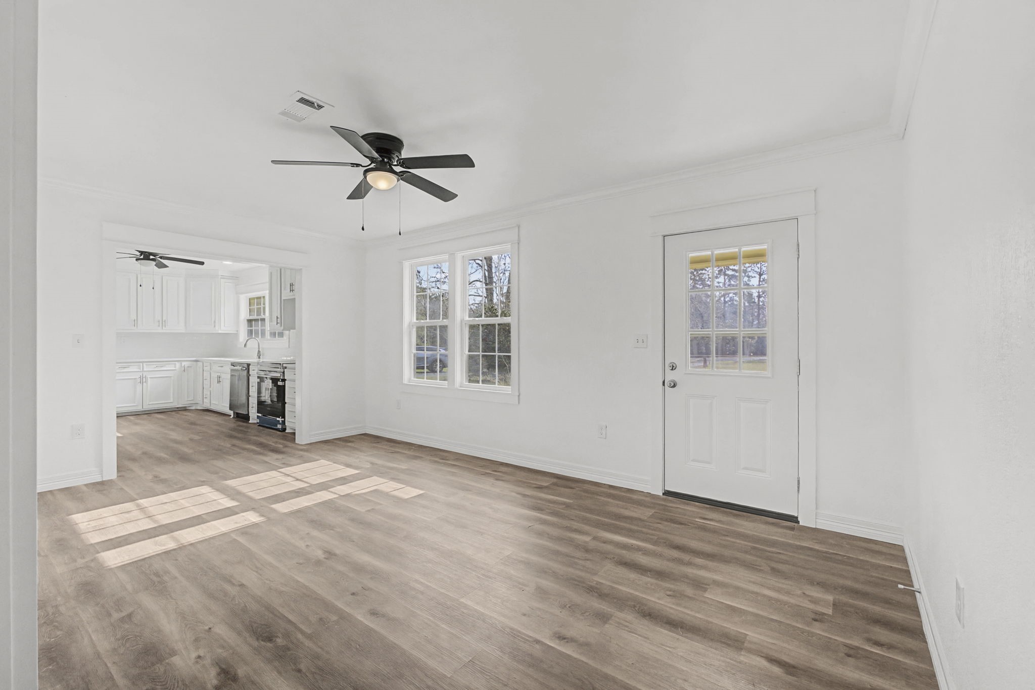 9216 Highway 69 Warren, TX 77664 - Photo 14 of 32 wooden floor in an empty room with a window