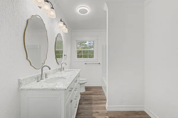 a bathroom with a granite countertop sink a mirror and a vanity