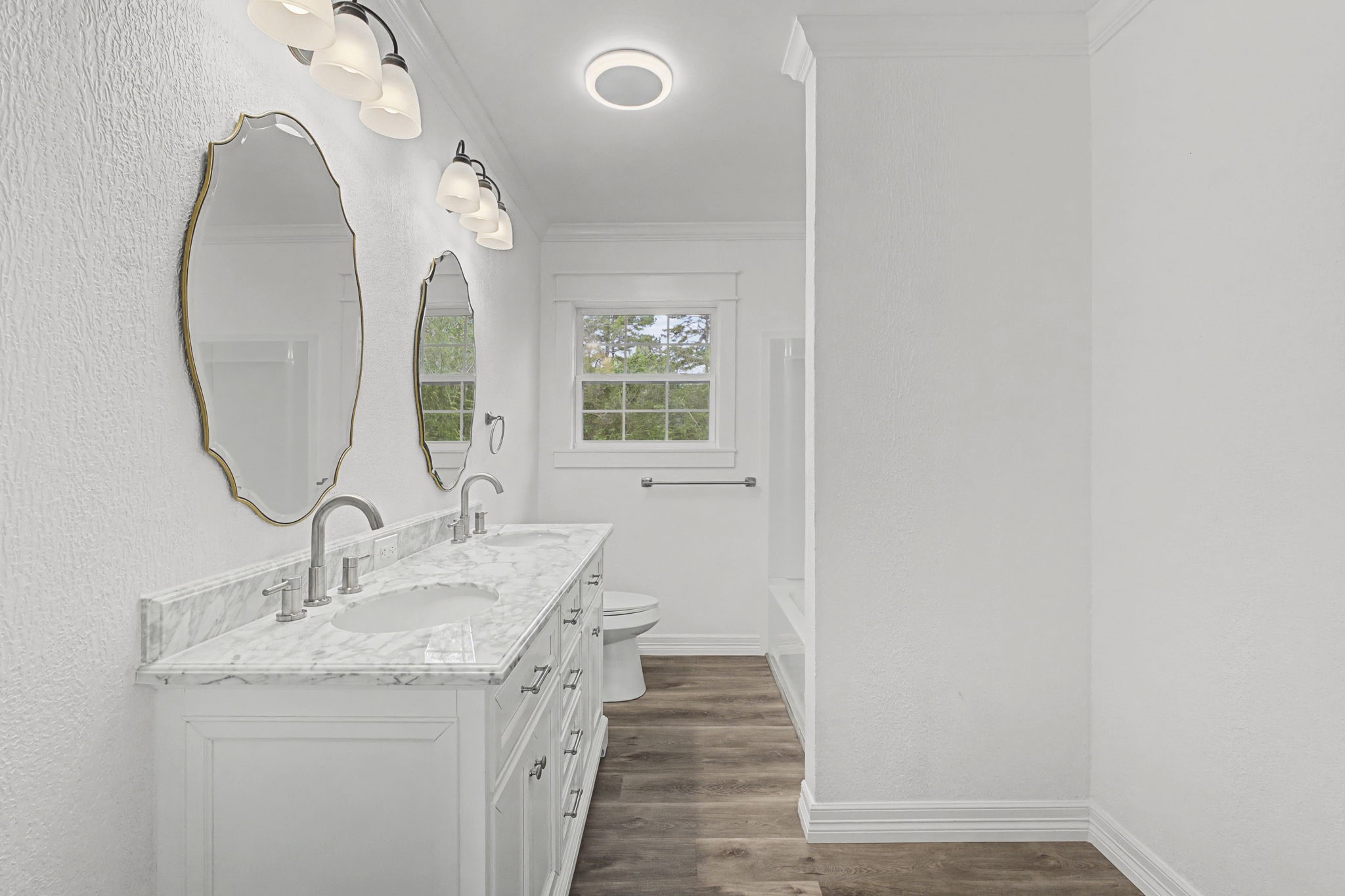 9216 Highway 69 Warren, TX 77664 - Photo 16 of 32 a bathroom with a granite countertop sink a mirror and a vanity