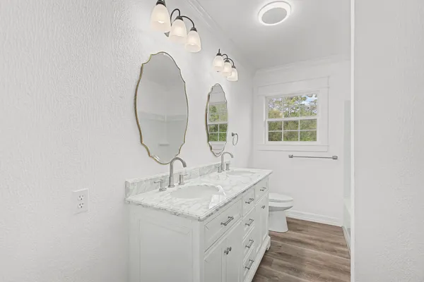 a bathroom with a double vanity sink and a mirror