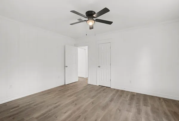 a view of empty room with wooden floor