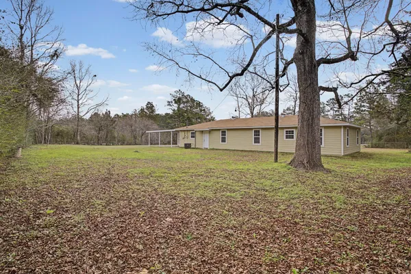 a view of a big house with a big yard