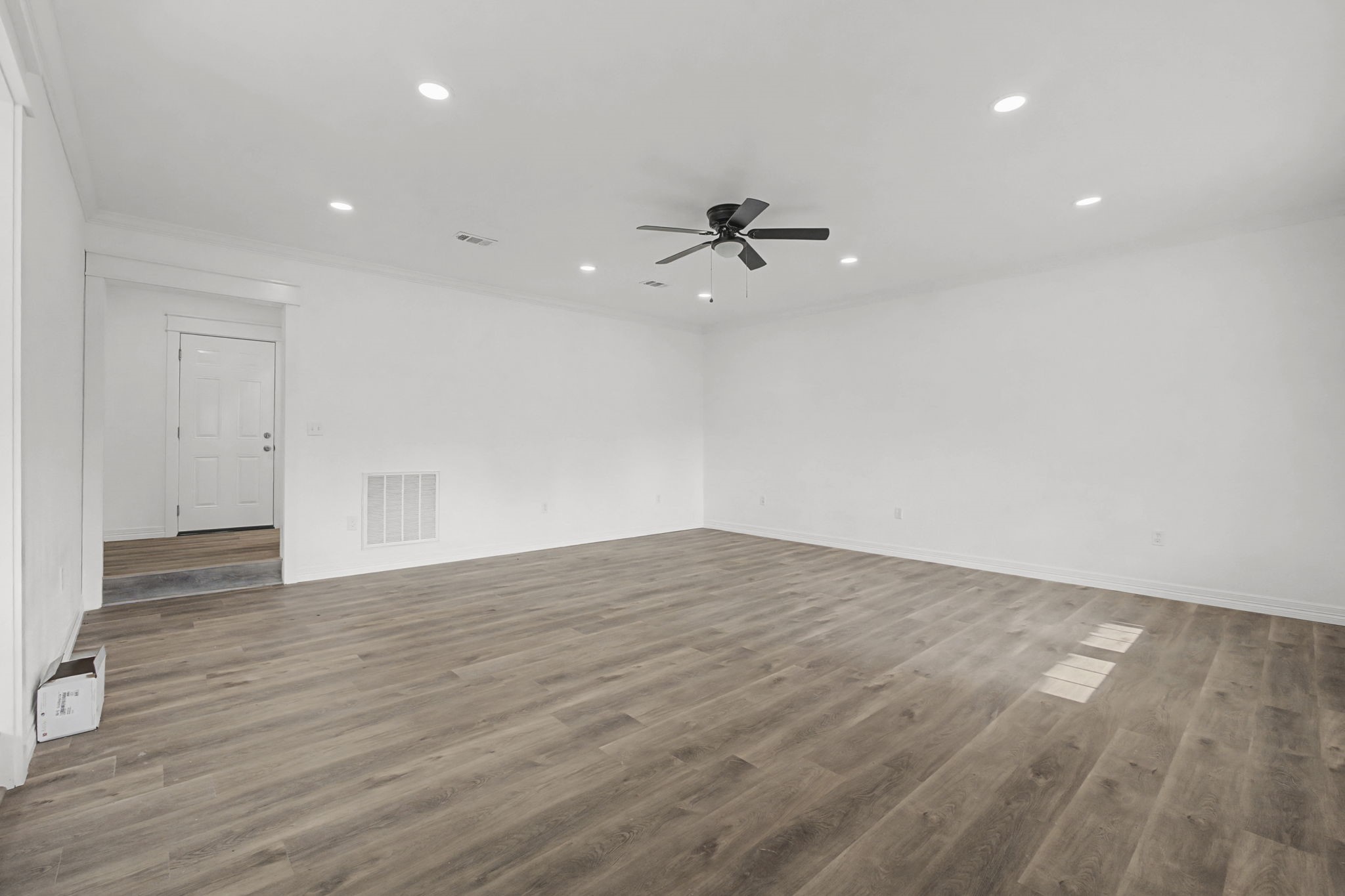 9216 Highway 69 Warren, TX 77664 - Photo 6 of 32 a view of empty room with wooden floor and ceiling fan