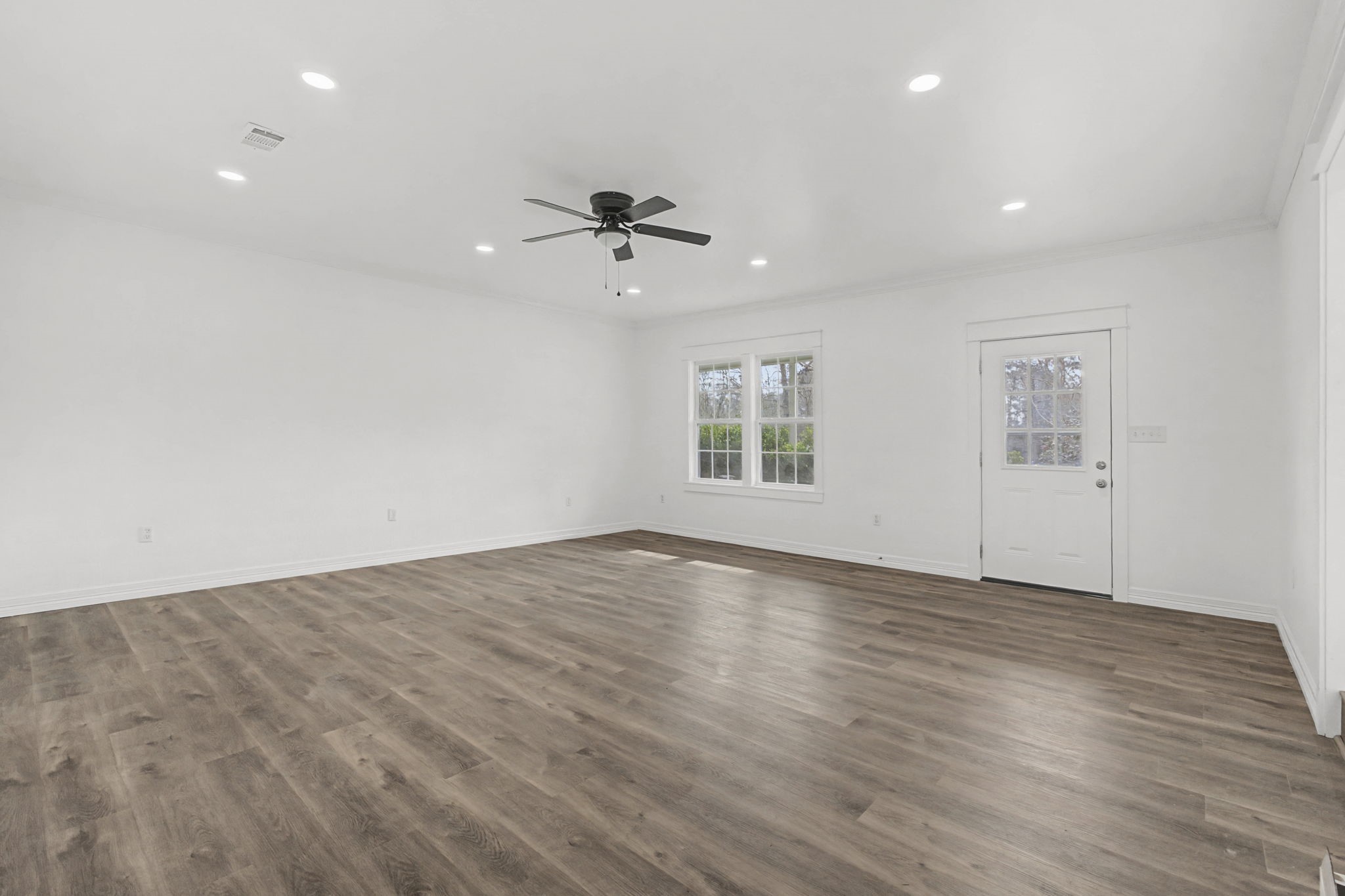 9216 Highway 69 Warren, TX 77664 - Photo 7 of 32 a view of an empty room with a window and wooden floor