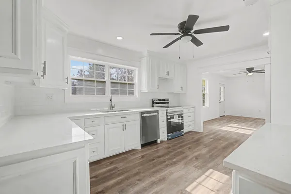 a kitchen with a stove a sink and a refrigerator