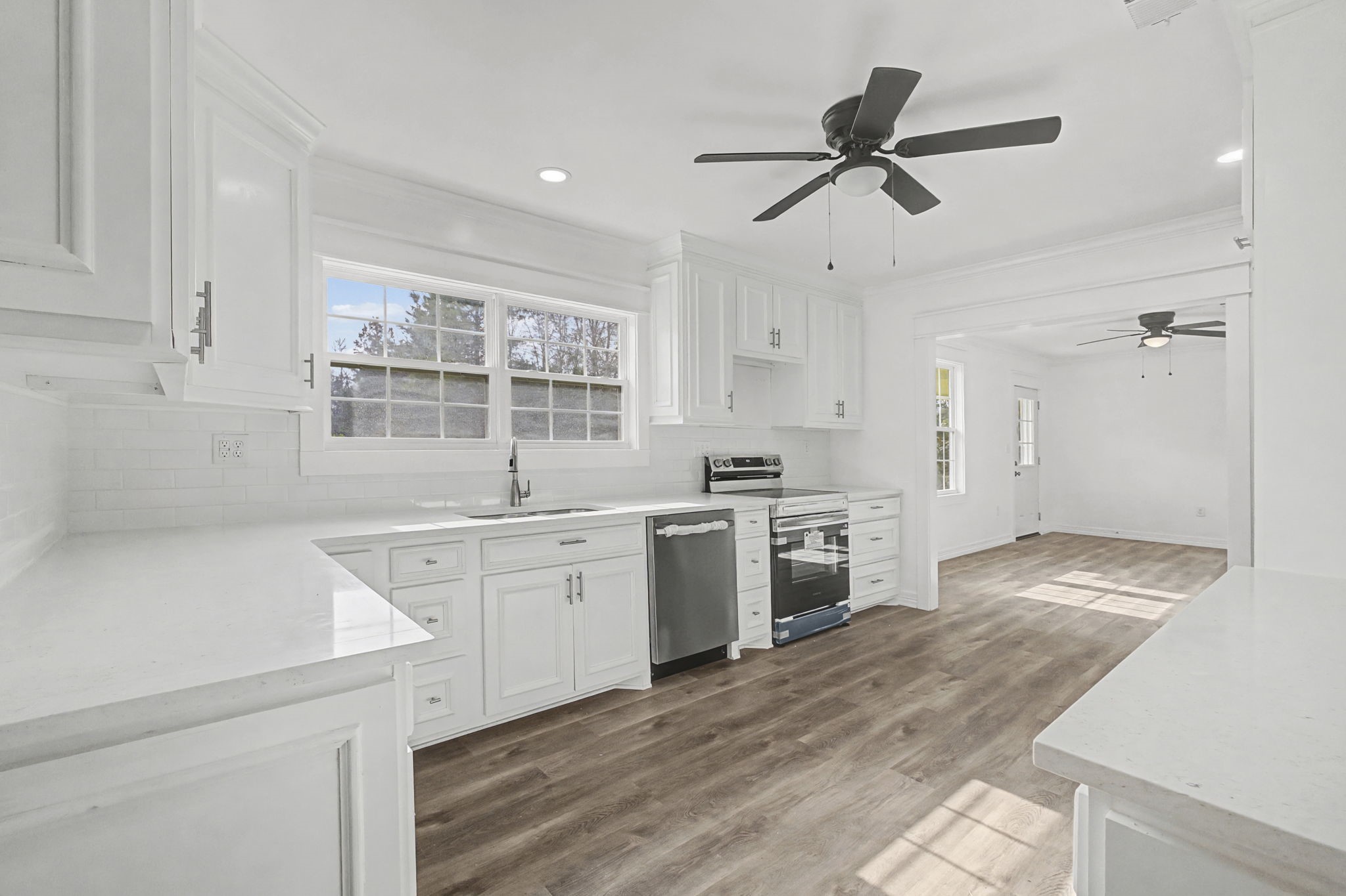9216 Highway 69 Warren, TX 77664 - Photo 9 of 32 a kitchen with a stove a sink and a refrigerator