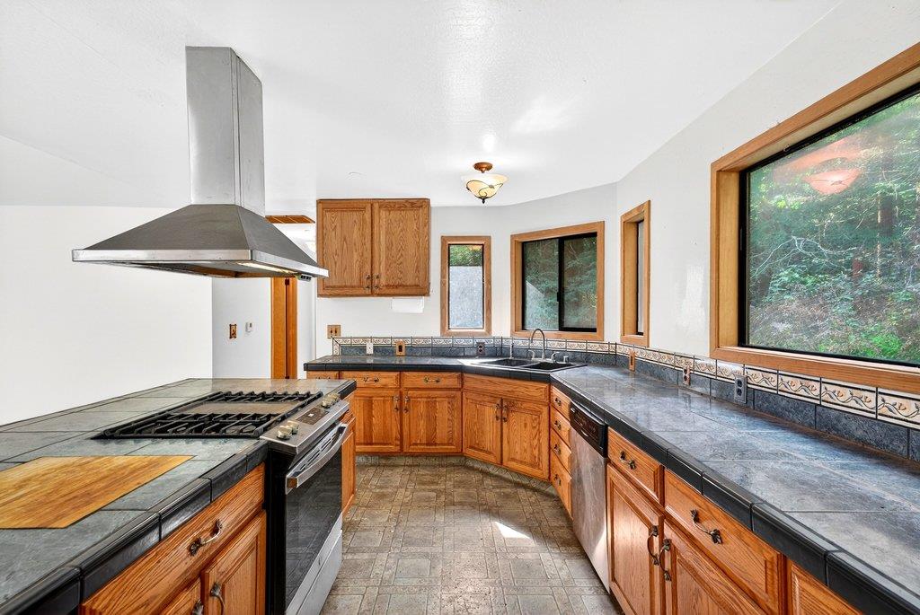 13033 Lompico Road Felton, CA 95018 - Photo 11 of 32 a kitchen with stainless steel appliances granite countertop a stove a sink and a refrigerator