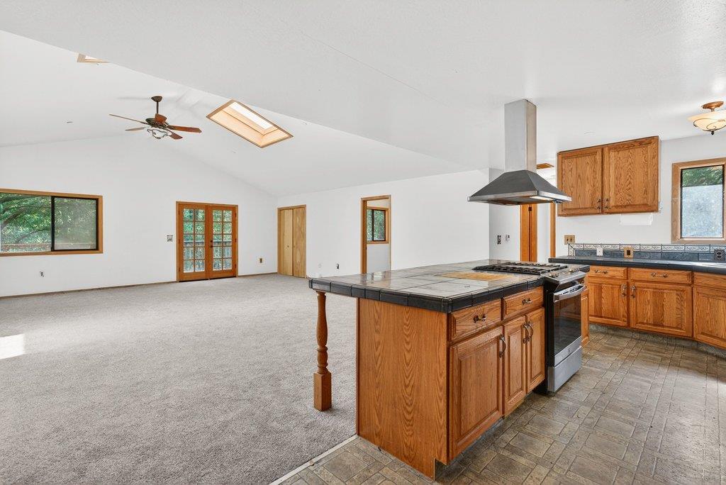 13033 Lompico Road Felton, CA 95018 - Photo 13 of 32 a kitchen with stainless steel appliances granite countertop a stove and a sink
