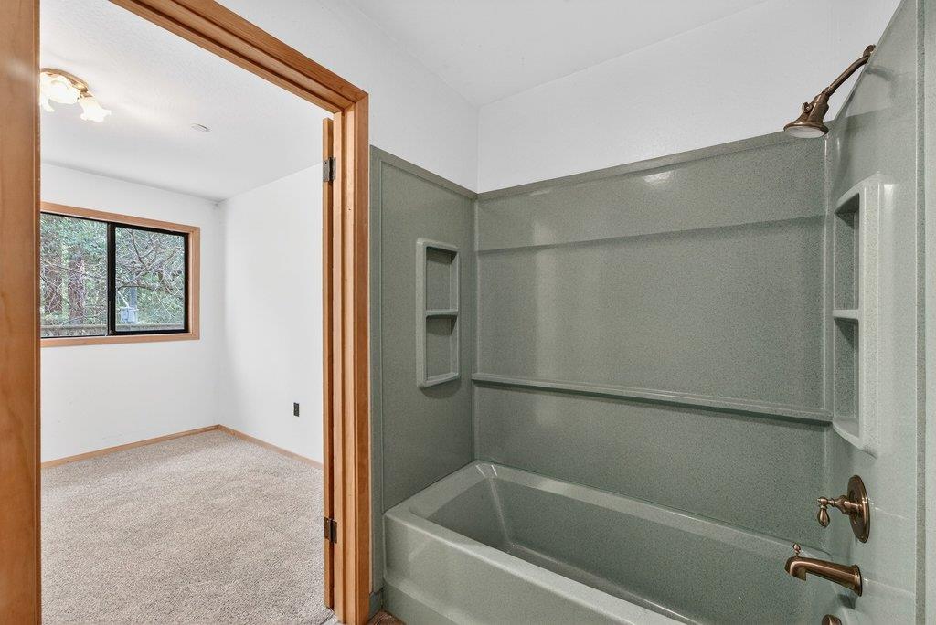 13033 Lompico Road Felton, CA 95018 - Photo 18 of 32 a bathroom with a bathtub and a shower