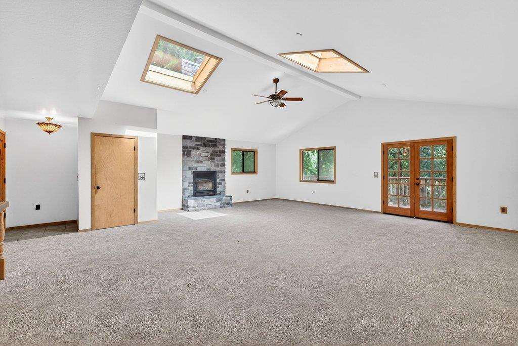 13033 Lompico Road Felton, CA 95018 - Photo 5 of 32 a view of a big room with windows and chandelier fan
