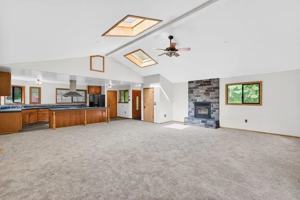 a view of a livingroom with furniture and a kitchen
