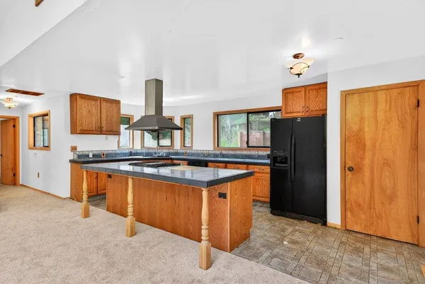 a kitchen with stainless steel appliances granite countertop a stove refrigerator and a window