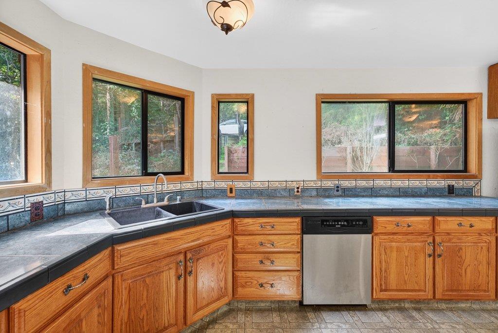 13033 Lompico Road Felton, CA 95018 - Photo 10 of 32 a kitchen with granite countertop a sink and a window