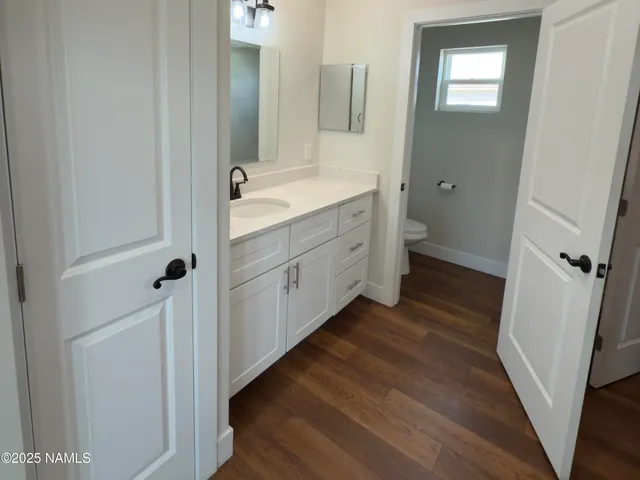 a bathroom with a double vanity sink toilet and shower