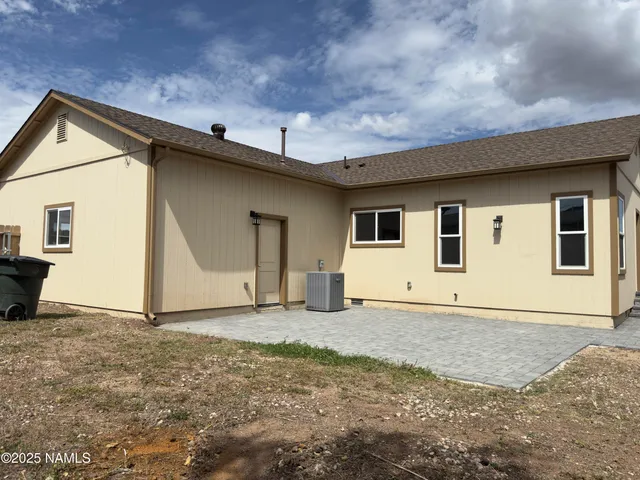 a kitchen with stainless steel appliances granite countertop a sink a stove top oven a counter space and wooden floor