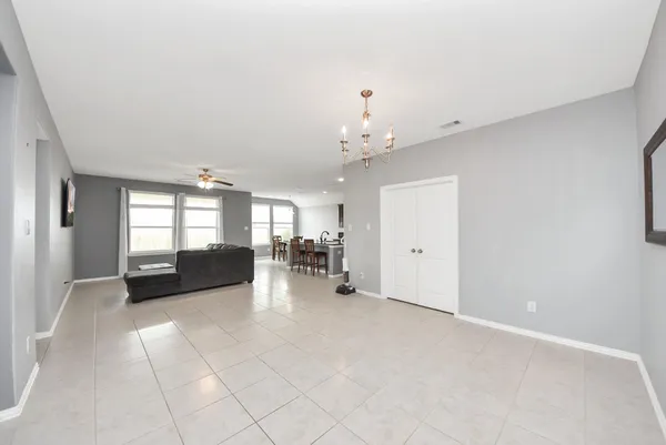 wooden floor with furniture and chandelier in it