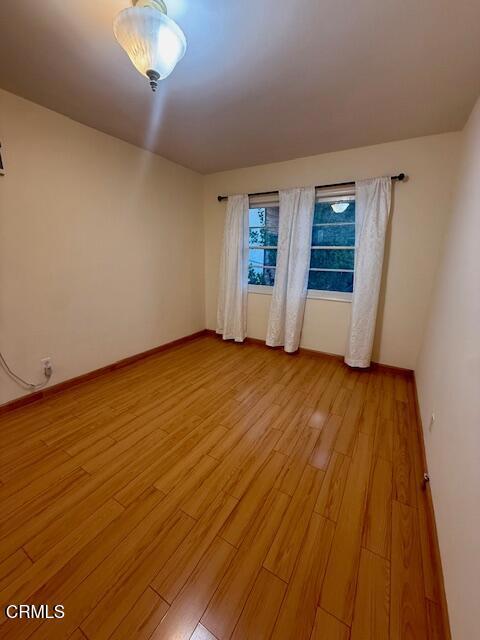 315 East California Avenue, Unit A Glendale, CA 91206 - Photo 10 of 11 wooden floor in an empty room with a window