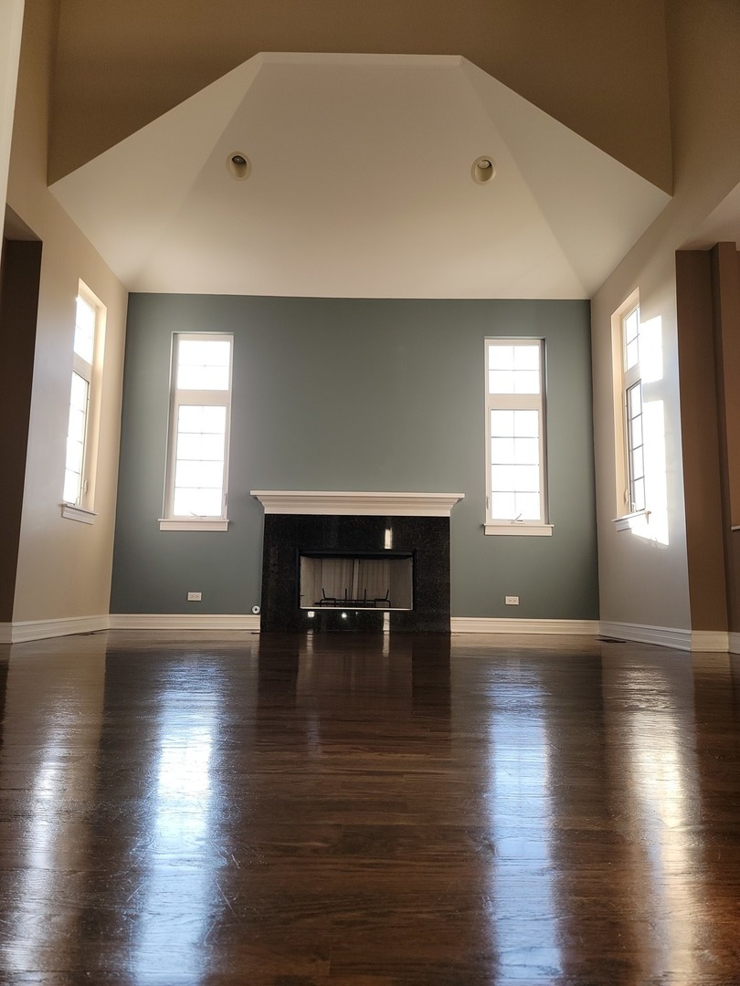 904 Deer Path Drive Antioch, IL 60002 - Photo 11 of 42 a view of empty room with wooden floor and fireplace