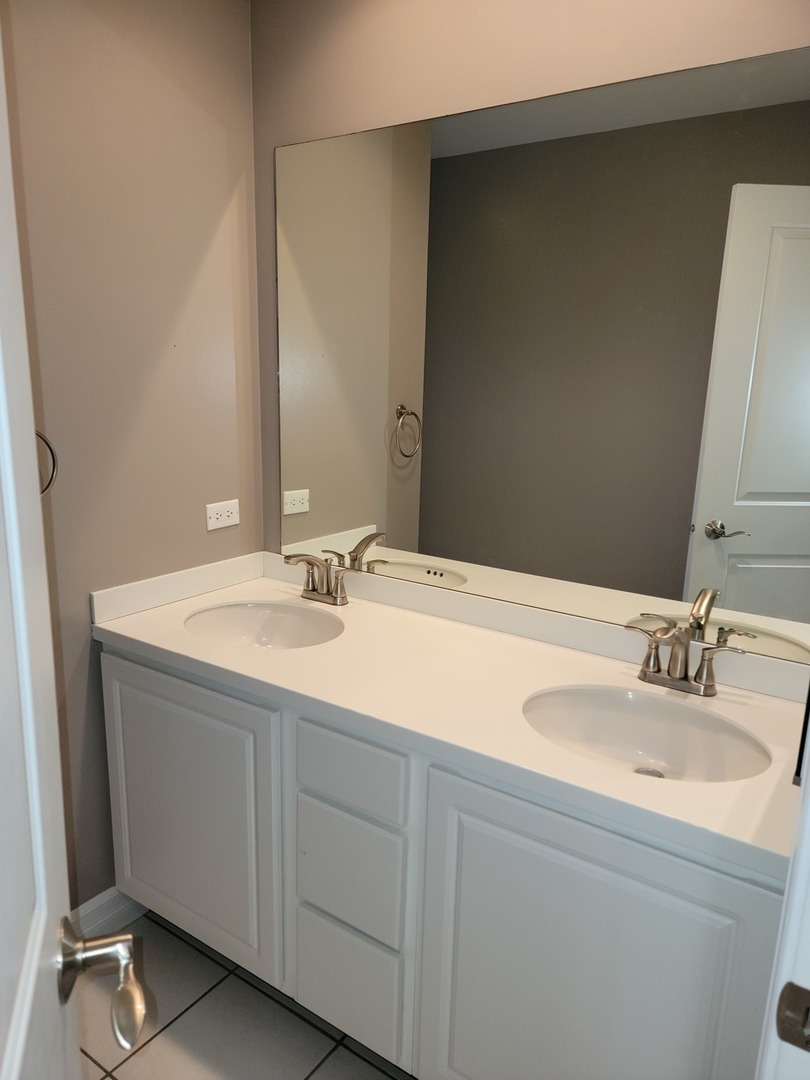 904 Deer Path Drive Antioch, IL 60002 - Photo 34 of 42 a bathroom with a sink and a mirror