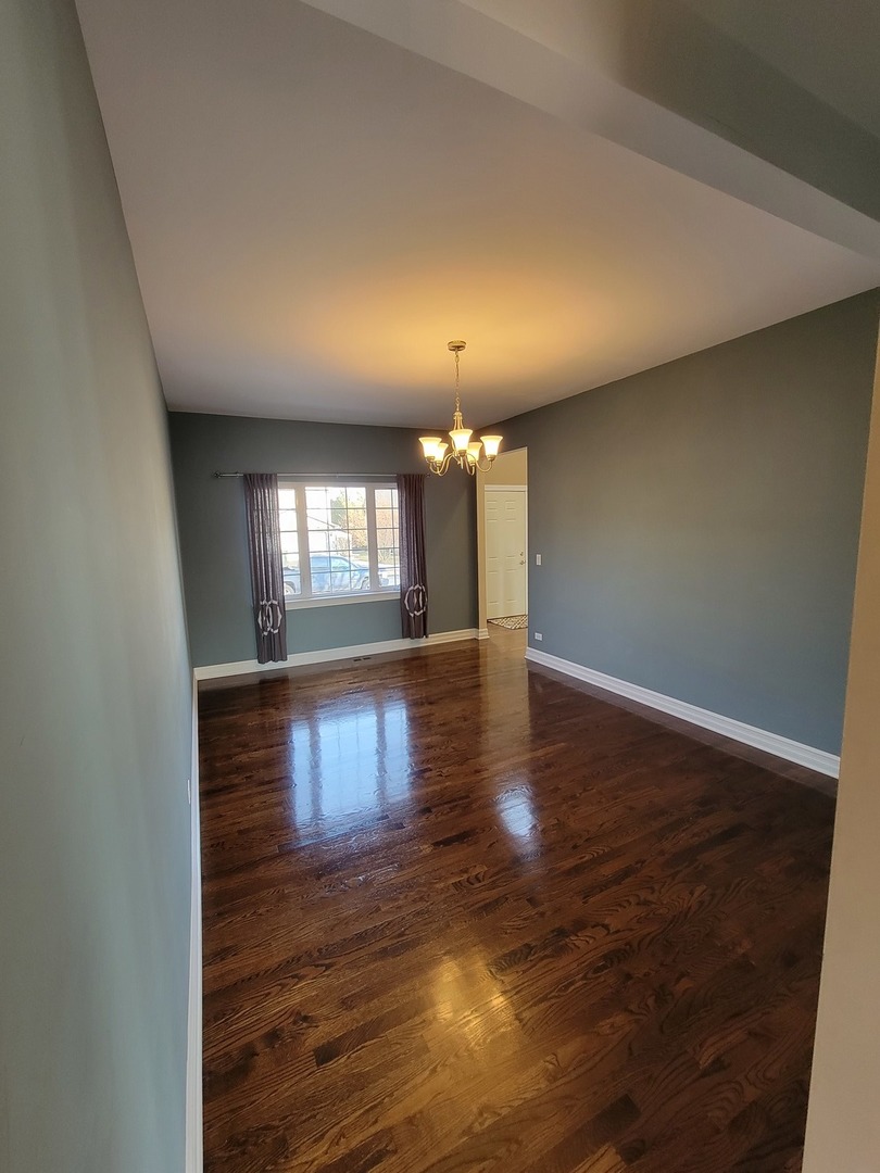 904 Deer Path Drive Antioch, IL 60002 - Photo 9 of 42 an empty room with wooden floor and windows