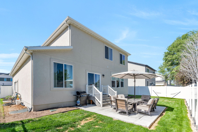 2664 West Maple Street Mapleton, UT 84664 - Photo 8 of 49 Rear exterior featuring a ground-level patio, white railing stairs, and sliding glass door