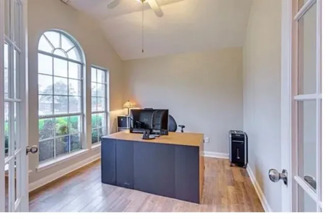 a view of a workspace with furniture and a window