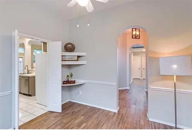 a bathroom with a tub a sink and mirror