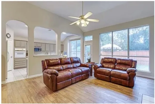 a living room with furniture and a large window