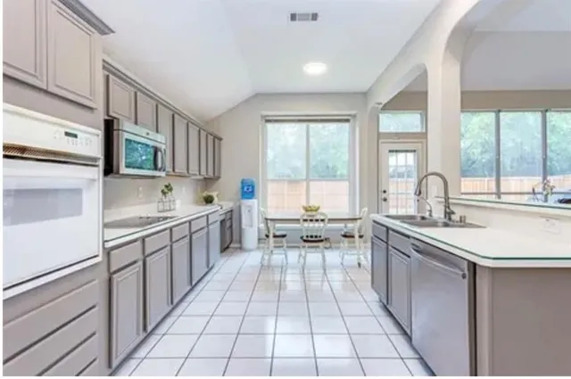 a kitchen with stainless steel appliances a sink stove and cabinets