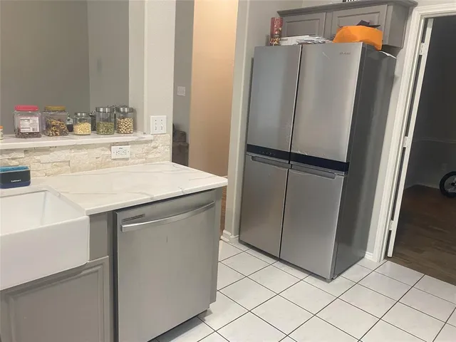 a kitchen with stainless steel appliances a refrigerator and a sink