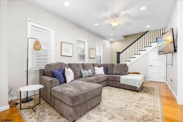 a living room with furniture and a chandelier