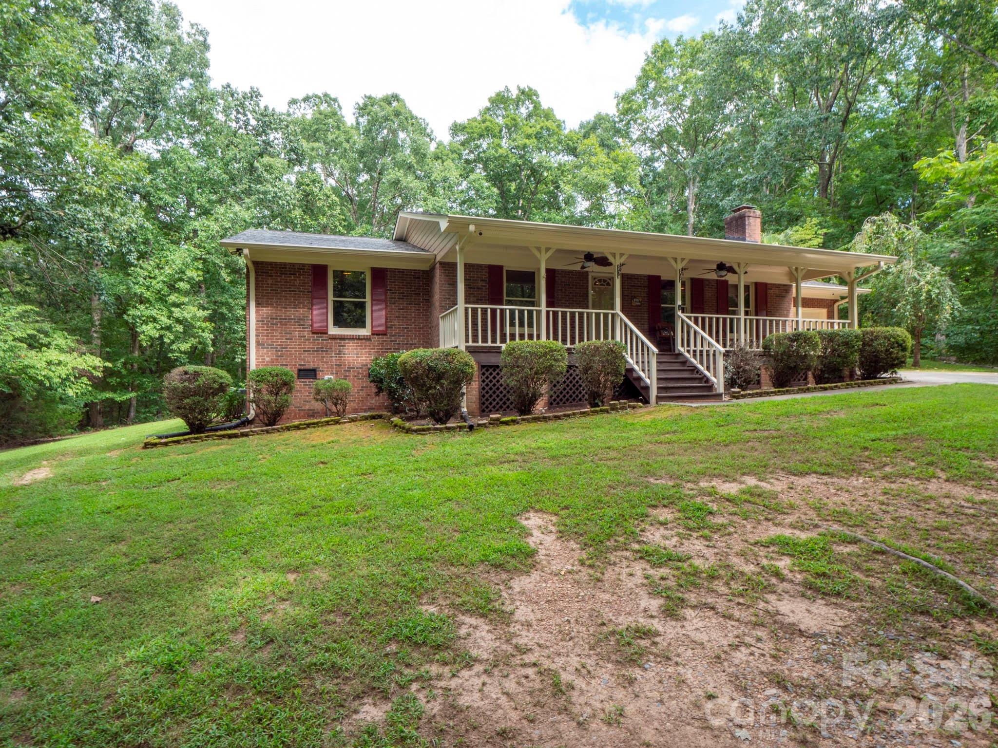 8720 Unionville-Brief Road Monroe, NC 28110 - Photo 3 of 35 a view of a house with backyard sitting area and garden
