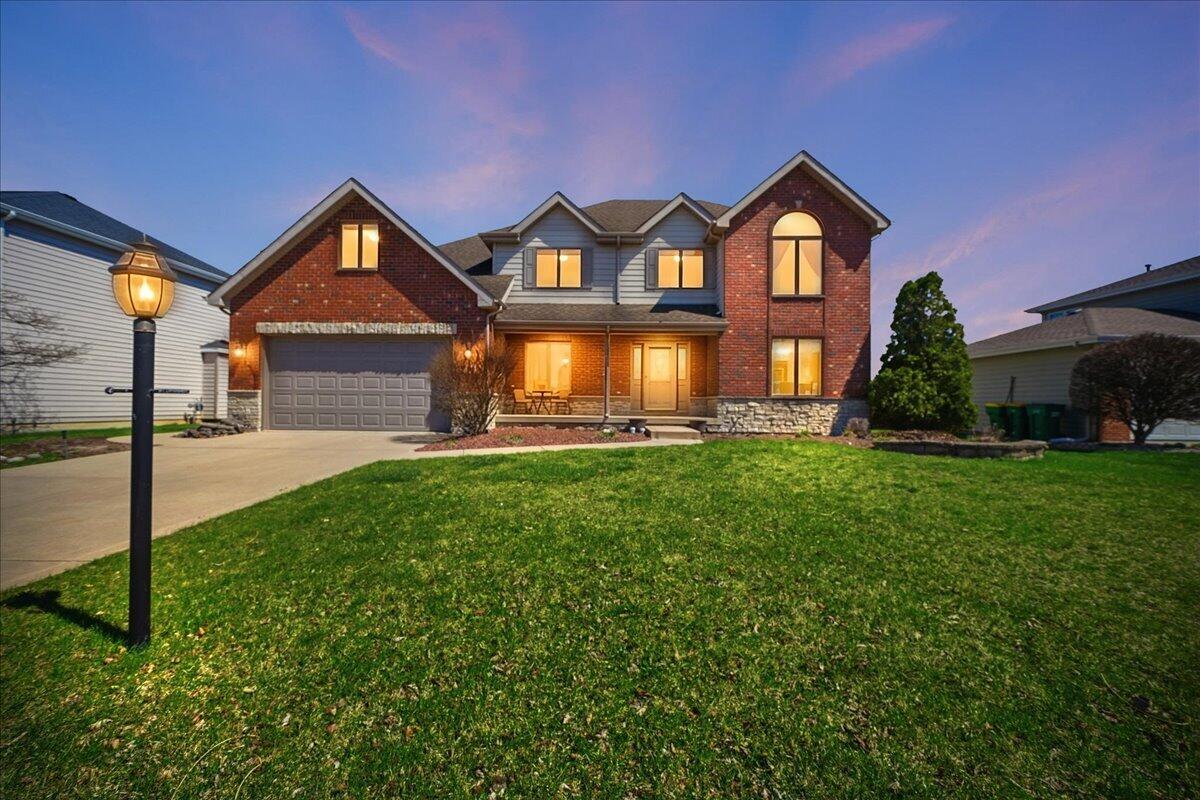 9741 Whitehall Garden Munster, IN 46321 - Photo 1 of 30 a front view of a house with a yard and outdoor seating