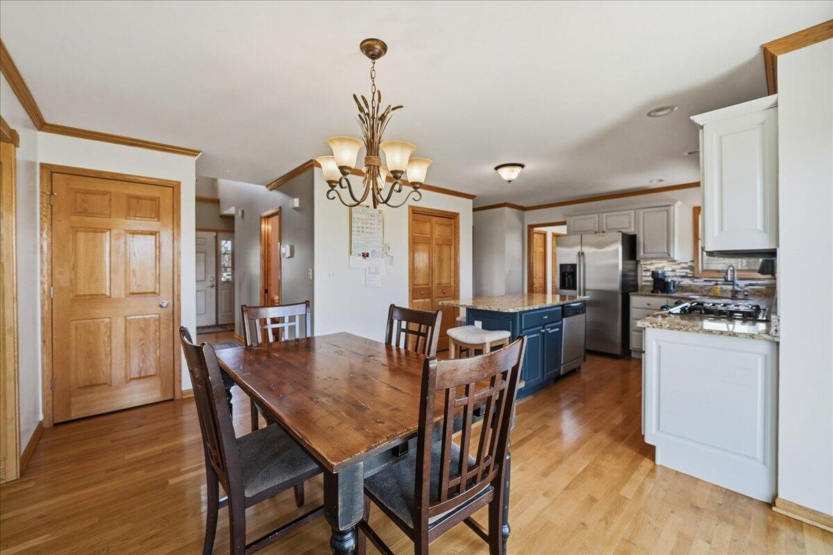 9741 Whitehall Garden Munster, IN 46321 - Photo 12 of 30 a view of a dining room with furniture window and wooden floor