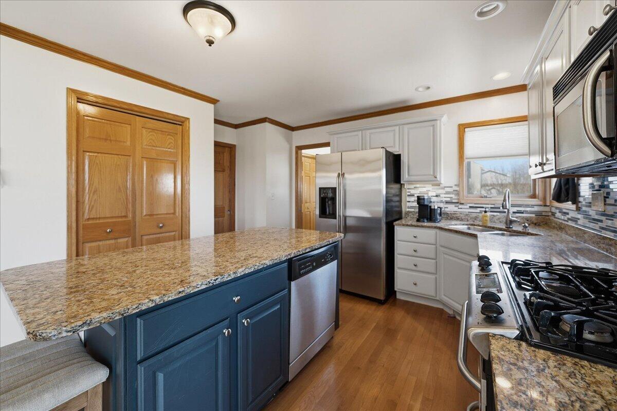 9741 Whitehall Garden Munster, IN 46321 - Photo 13 of 30 a kitchen with stainless steel appliances granite countertop a sink stove and refrigerator