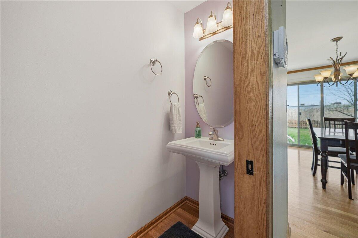 9741 Whitehall Garden Munster, IN 46321 - Photo 16 of 30 a bathroom with a sink a mirror and wooden floor